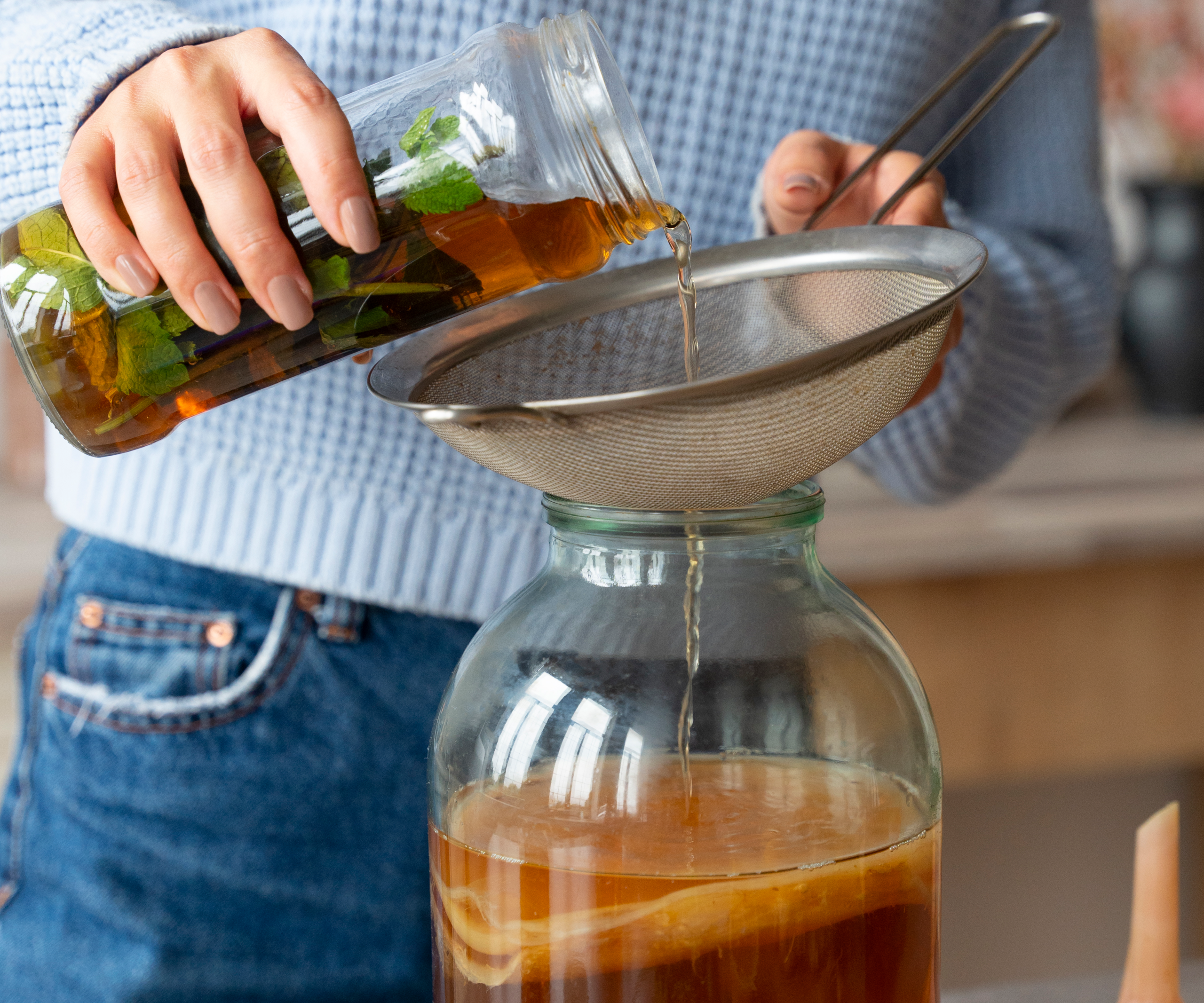 front-view-woman-preparing-kombucha